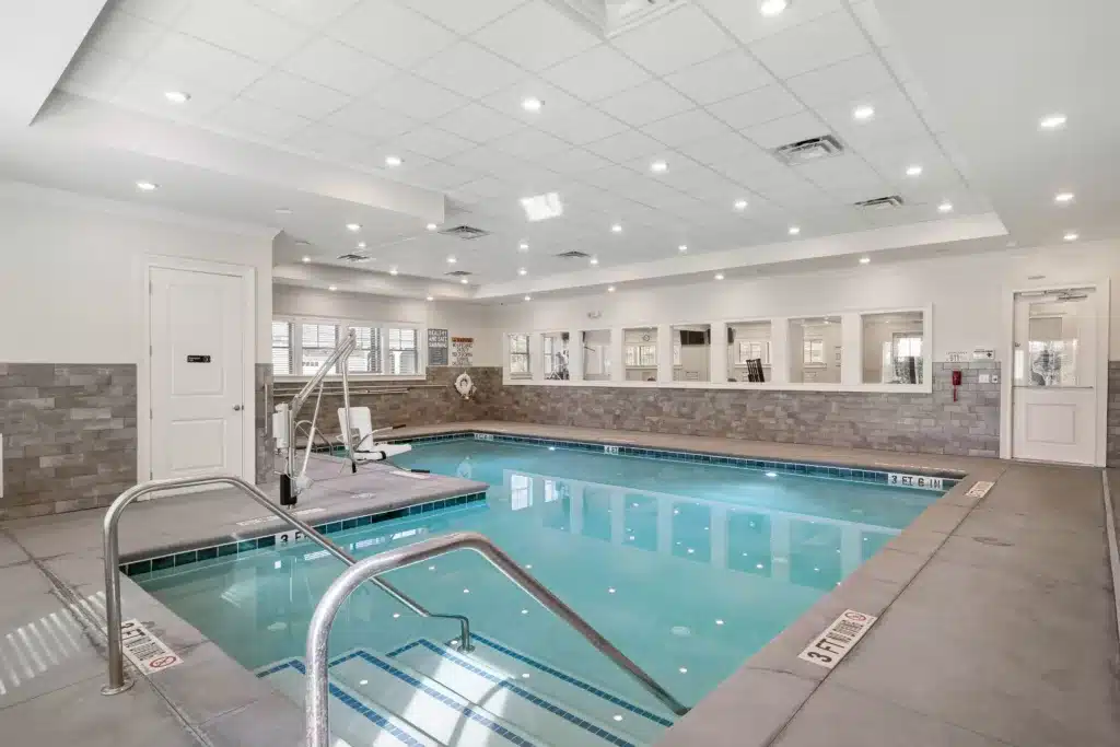 Luxurious swimming pool at The Mansions at Gwinnett Park Senior Independent Living community in Alpharetta, Georgia, featuring serene water and a relaxing environment for active seniors